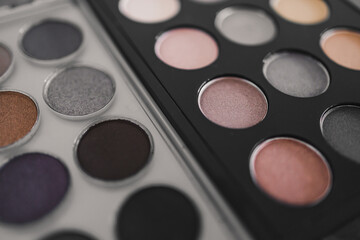 cosmetics and beauty, close-up of two similar eyeshadow palettes with neutral nude tones next to...