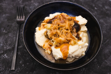 plant-based food, vegan sausages with dairy-free mash potatoes and sauerkraut topping with mushroom gravy