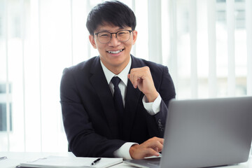 Attractive asian smiling businessman in office place, Confident young man.