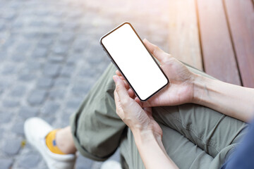cell phone mockup image blank white screen.woman hand holding texting using mobile at outdoor.background empty space for advertise.work people contact marketing business,technology