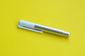 top view of the stylus pen on yellow background
