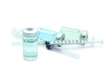 doctor's hand holds a syringe and a blue vaccine  Remdesivir bottle at the hospital. Health and medical concepts