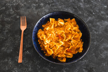 plant-based food, vegan bowtie pasta with red pesto and mediterranean vegetables