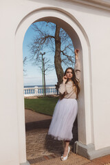 Fototapeta premium Girl in a white tutu in a city garden