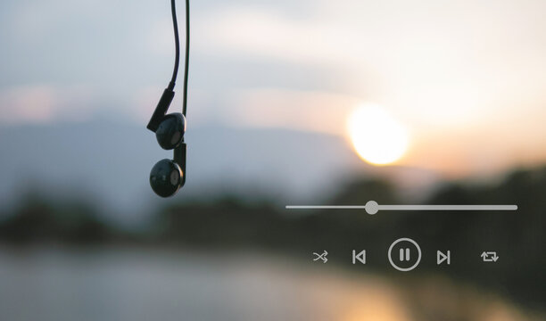 Headphones and playlist listen to music at sunset