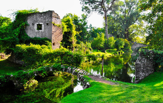 Garden of ninfa: detail of ruins and stone bridges on the river