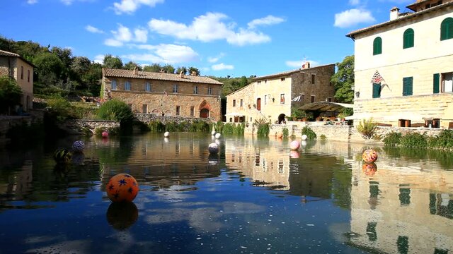 The beautiful old pond with mineral water in the central square of Bagno Vignoni attracts many tourists and is a natural attraction of Tuscany, Italy