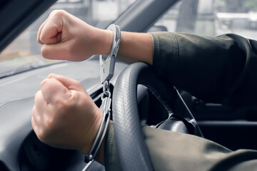 the detained driver of the car handcuffed to the steering wheel clenched his fists