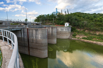 Dam at reservoir station in a clear sunny day, reservoir for innovations in agriculture industry, The lake water is formed by the damming