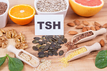 Inscription TSH with products and ingredients as source healthy vitamins and minerals. Beneficial eating for thyroid gland