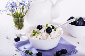 healthy breakfast cottage cheese in white bowl with fresh summer  berries