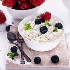 healthy breakfast cottage cheese in white bowl with fresh summer  berries