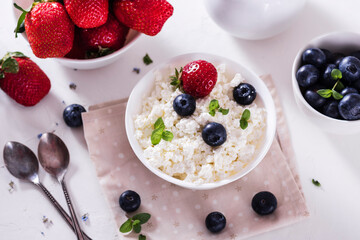 healthy breakfast cottage cheese in white bowl with fresh summer  berries