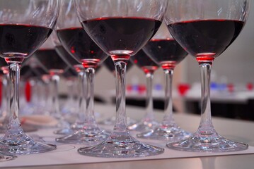 Close up view of rows of red wine glasses