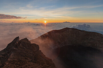 sunrise at the top of agung volcano. crater view. Higher than clouds. rinjani view. High quality photo. Bali - island of gods. Indonesian mountains. trekking rote to summit. 