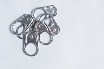 A selection of metal ring pulls for canned food or drinks isolated over white background.