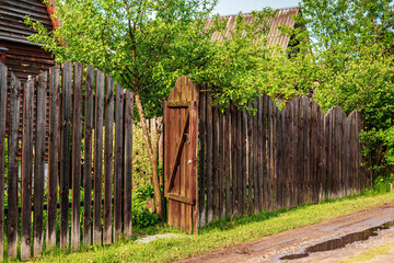 Open gate in a wooden fence