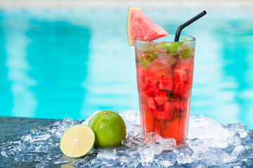 Water melon juice with swimming pool background