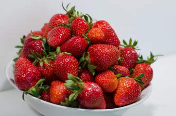 Large bowl of strawberries isolated on a white background