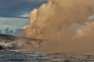 Fototapeta na wymiar Volcanic lava flows into ocean waves