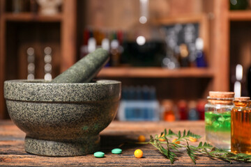 Different potions, mortar and pestle on alchemist's table