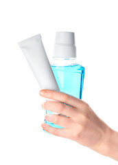 Female hand with tooth paste and mouthwash on white background