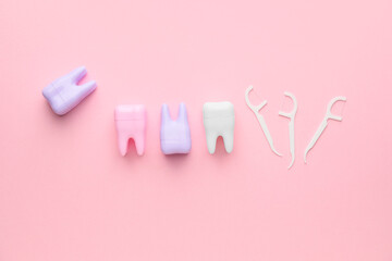 Teeth with dental floss on color background