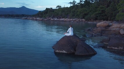 woman doing yoga and meditating in the nature