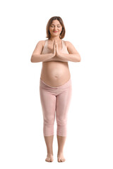 Fototapeta premium Young pregnant woman practicing yoga on white background