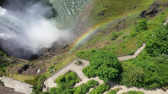 Aerial / drone footage of a rainbow over Snoqualmie River and Falls by Issaquah and North Bend near Seattle, Washington during the COVID-19 pandemic closure