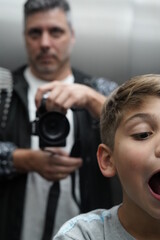 
father and son doing a self portrait