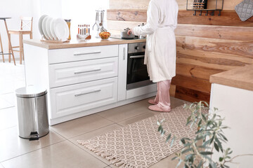 Woman cooking in stylish kitchen at home