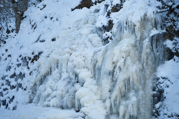 Icy waterfall on a mountain river.