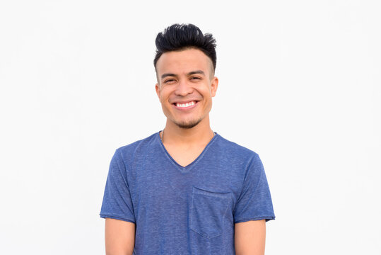 Face of happy young handsome multi ethnic man smiling against white background