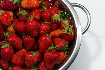 Strawberries in a big bowl on white background isolated