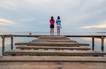 people walk on the bridge over the sea in the morning