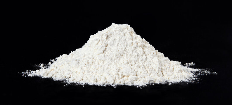A pile of flour isolated on black background. Full depth of field.