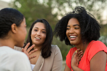 Diverse group of friends talking and laughing.