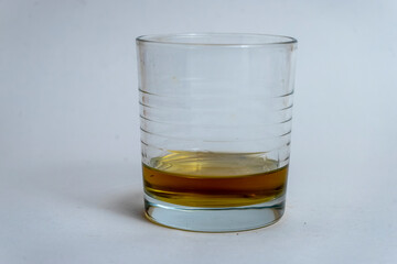 glass of whiskey with no ice on a white background