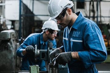 Fototapeta na wymiar Engineer men wearing uniform safety maintenance in factory working machine lathe metal, Professional worker man.