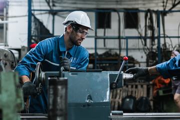 Engineer men wearing uniform safety maintenance in factory working machine lathe metal, Professional worker man.