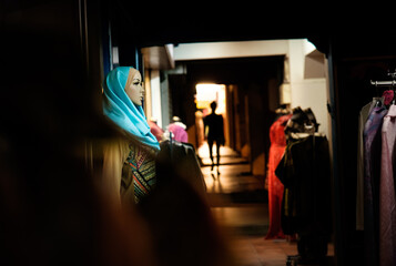 mannequin with hijab on streets with silhouette in background