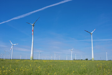 Modern wind wheels with a clear blue sky seen in Germany