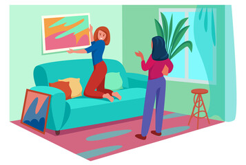 two fashionable women decorate interior, select a picture of modern abstract painting, arrange flowers