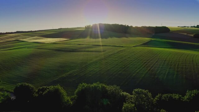 Aerial view of solar farm, sunset. Rows of modern photovoltaic solar panels. Renewable ecological source of energy from the sun.