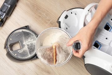 Vacuum cleaner and garbage container full of fur, dust and dirt. Household chores or cleaning company.