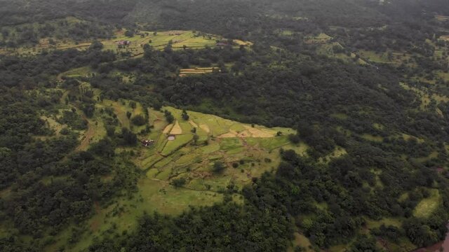 Aerial drone view of Indian village with farms in rain, Maharashtra, India