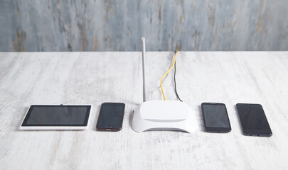 Internet router with a smartphones and tablet on the desk. Network, Technology