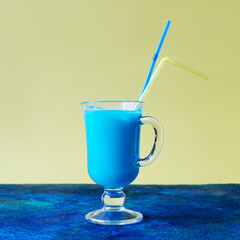 Blue cocktail on yellow blue background.