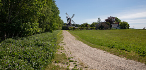 Fototapeta na wymiar Road to the old windmill with blue sky